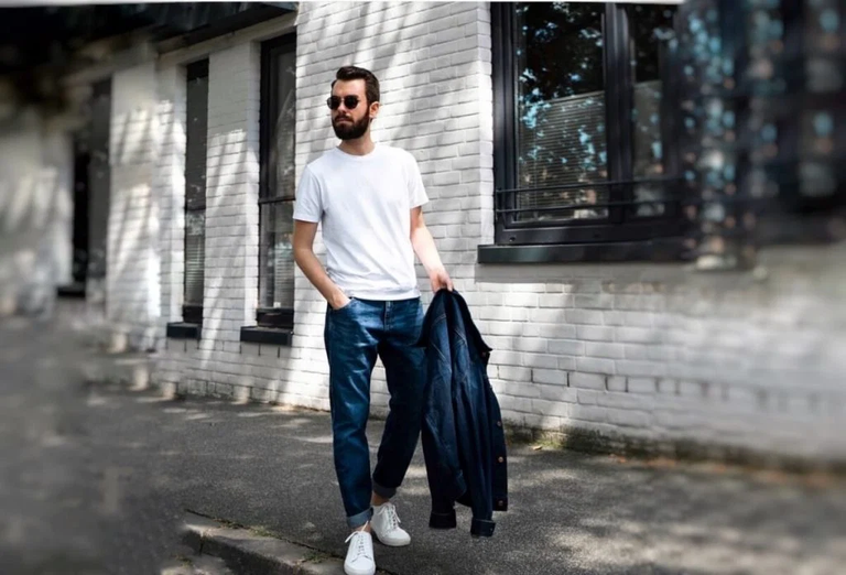 How to style a t shirt in 2026, layered with a denim jacket over jeans