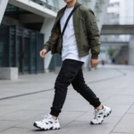 Man showing how to wear a jacket in 2026 with cargo joggers and an oversized T-shirt