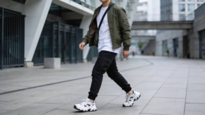 Man showing how to wear a jacket in 2026 with cargo joggers and an oversized T-shirt